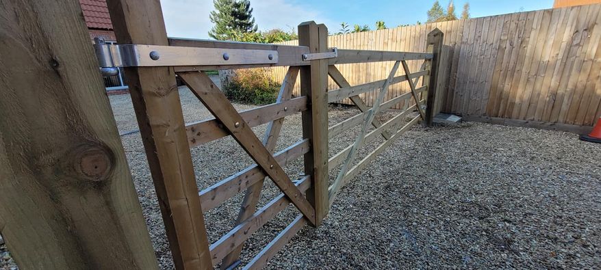Timber pedestrian gate beside a fence