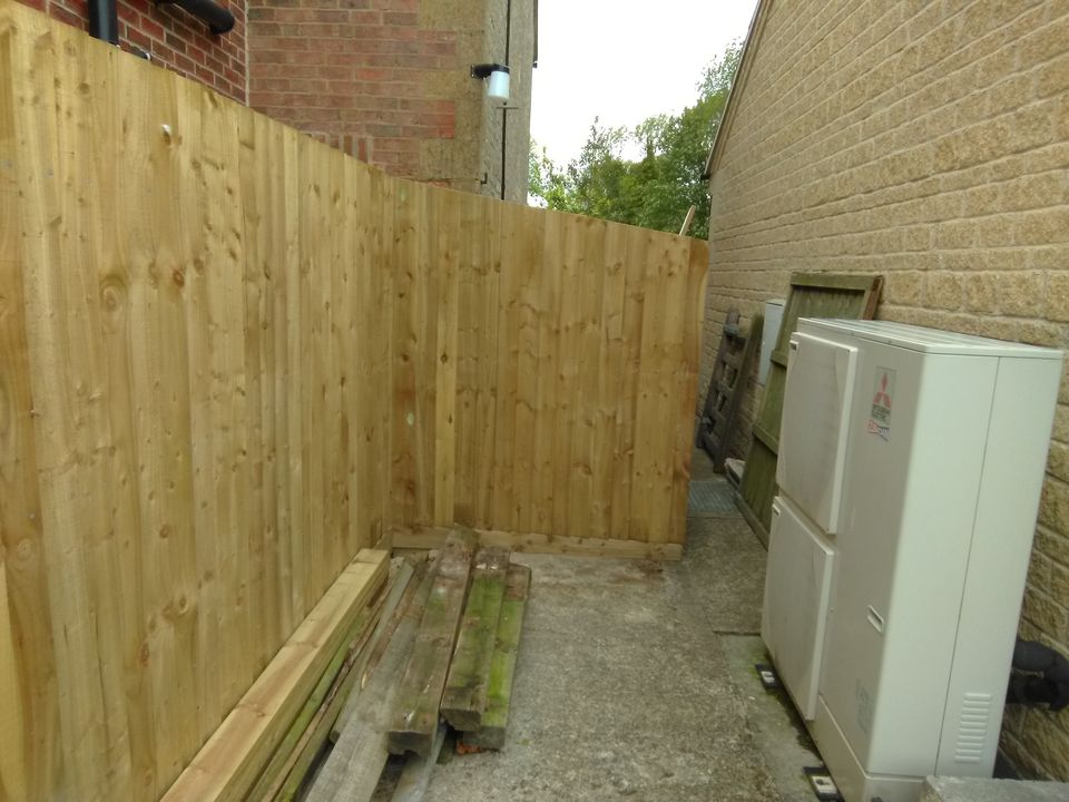 Close-board timber fencing along a side passage